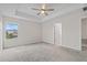 Inviting bedroom boasts soft carpet, a modern fan and a bright window with neighborhood views at 9069 Pinch Shot Dr, Winter Garden, FL 34787