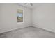 Cozy bedroom with a neutral palette, plush carpeting, and a bright window at 9069 Pinch Shot Dr, Winter Garden, FL 34787