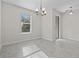 Bright dining room with decorative lighting, a window, and tile flooring at 9069 Pinch Shot Dr, Winter Garden, FL 34787