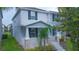 Charming two-story home with a welcoming front porch, complemented by tasteful blue shutters at 9069 Pinch Shot Dr, Winter Garden, FL 34787