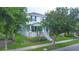 Charming home with a landscaped front yard and cozy front porch at 9069 Pinch Shot Dr, Winter Garden, FL 34787