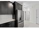 Well-equipped kitchen with stainless steel refrigerator and dark cabinets, offering plenty of storage at 9069 Pinch Shot Dr, Winter Garden, FL 34787