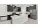 Stylish kitchen with dark cabinets, stainless steel appliances, and a large center island with a sink at 9069 Pinch Shot Dr, Winter Garden, FL 34787