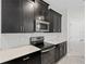 Modern kitchen with stainless steel appliances and subway tile backsplash and dark cabinetry at 9069 Pinch Shot Dr, Winter Garden, FL 34787