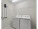 Clean laundry room with appliances, shelving, and tile flooring at 9069 Pinch Shot Dr, Winter Garden, FL 34787