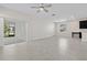 Bright and open living room with tile flooring, a ceiling fan, and sliding glass doors to the patio at 9069 Pinch Shot Dr, Winter Garden, FL 34787