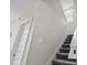 Carpeted staircase with white walls, baseboards, and a window for lots of natural light at 9069 Pinch Shot Dr, Winter Garden, FL 34787