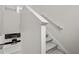 Carpeted stairs leading to a spacious living area and modern kitchen at 9069 Pinch Shot Dr, Winter Garden, FL 34787