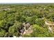 Aerial view of the home amidst a heavily wooded area at 9536 Peer Dr, Orlando, FL 32817