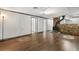 This is a view of a room with wood floors, a brick accent wall with an insert, and access to another room at 9536 Peer Dr, Orlando, FL 32817