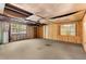 This unfinished basement has concrete floors, unfinished walls, a window, and a ceiling fan at 9536 Peer Dr, Orlando, FL 32817