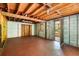 This unfinished basement has concrete floors, a block foundation, exposed wood beams, and a door to the outside at 9536 Peer Dr, Orlando, FL 32817