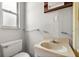 This bathroom has a window, toilet, vanity with sink and mirrored medicine cabinet above at 9536 Peer Dr, Orlando, FL 32817