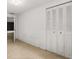 This bedroom features light walls, neutral flooring, and a large closet with shuttered doors at 9536 Peer Dr, Orlando, FL 32817
