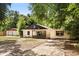 Exterior front view of a single-story home with a yard and a detached garage at 9536 Peer Dr, Orlando, FL 32817