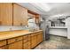 Kitchen with wood cabinets, a stainless steel refrigerator, and a double basin sink at 9536 Peer Dr, Orlando, FL 32817