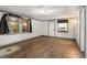 Living room with wood floors, a window, and white brick walls with gray trim at 9536 Peer Dr, Orlando, FL 32817