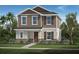 Charming two-story home featuring neutral-toned exterior, decorative shutters, and professionally landscaped yard at 9644 Westside Hills Dr, Davenport, FL 33896