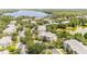 Aerial view of condos, parking, and landscaping, situated near a lake and ponds at 1109 New Providence # 141109, Davenport, FL 33897