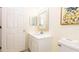 Bathroom featuring a sink, toilet, mirror, and cabinet space at 1109 New Providence # 141109, Davenport, FL 33897