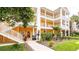 Condo building shows landscaped grounds, covered walkways, and exterior stairs to upper units at 1109 New Providence # 141109, Davenport, FL 33897