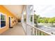 Upper level walkway with white railings offers view of parking and greenery at 1109 New Providence # 141109, Davenport, FL 33897
