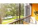 This screened patio offers outdoor seating, a view of the walking path, water, and mature trees at 1109 New Providence # 141109, Davenport, FL 33897