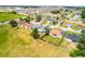Aerial view of a light blue home in a neighborhood with large lawn and mature trees at 141 Winsor Ave, Davenport, FL 33837