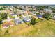 Aerial view of a light blue home with a fenced yard, nestled in a quiet, suburban neighborhood at 141 Winsor Ave, Davenport, FL 33837