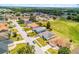 Aerial view of a light blue home in a friendly neighborhood with well-manicured lawns and tree-lined streets at 141 Winsor Ave, Davenport, FL 33837