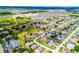 An aerial view of a neighborhood featuring green spaces and well-maintained homes, under a clear sky at 141 Winsor Ave, Davenport, FL 33837
