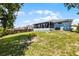 Spacious backyard featuring a lawn, a privacy fence and an enclosed porch at 141 Winsor Ave, Davenport, FL 33837