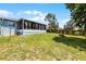 Spacious backyard featuring a well-maintained lawn and an enclosed porch at 141 Winsor Ave, Davenport, FL 33837