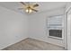 Simple bedroom with neutral walls, a ceiling fan, carpeted floor and a window providing natural light at 141 Winsor Ave, Davenport, FL 33837
