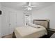 Bedroom with neutral walls, a ceiling fan, and a window letting in natural light at 141 Winsor Ave, Davenport, FL 33837