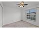 Simple bedroom with neutral walls, carpeted floor, a ceiling fan, and a window with blinds at 141 Winsor Ave, Davenport, FL 33837