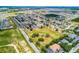 A serene community aerial view showcases organized housing layouts complemented by surrounding natural beauty at 141 Winsor Ave, Davenport, FL 33837