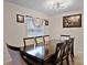 Formal dining room showcasing elegant lighting, neutral walls, and a large table with seating at 141 Winsor Ave, Davenport, FL 33837