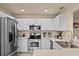 A modern kitchen featuring stainless steel appliances, white cabinets, and well-lit recessed lighting at 141 Winsor Ave, Davenport, FL 33837