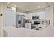 Bright kitchen features stainless appliances, recessed lighting, a pantry, and ample counter space at 141 Winsor Ave, Davenport, FL 33837