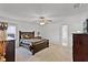 Spacious bedroom featuring neutral carpeting, ceiling fan, and a closet for ample storage at 141 Winsor Ave, Davenport, FL 33837