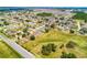 A wide aerial shot displays a community with a mix of housing styles and proximity to green spaces at 141 Winsor Ave, Davenport, FL 33837