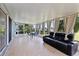 Enclosed sunroom with tile flooring, curtains for privacy, and comfortable seating at 141 Winsor Ave, Davenport, FL 33837
