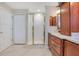 Bathroom features a tile shower with glass doors, double door closet, and tile flooring at 14244 Nottingham Way Cir, Orlando, FL 32828