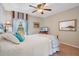 Inviting bedroom with a wooden bed frame, light carpet, and a cozy ambiance enhanced by soft lighting at 14244 Nottingham Way Cir, Orlando, FL 32828