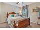 Comfortable bedroom with wooden bed frame, light carpet, and blue accents, creating a welcoming atmosphere at 14244 Nottingham Way Cir, Orlando, FL 32828