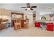 Bonus room features a wet bar, ceiling fan, carpet, and cozy sitting area at 14244 Nottingham Way Cir, Orlando, FL 32828