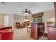 Bonus room includes a wet bar, seating, carpet, ceiling fan, and natural light at 14244 Nottingham Way Cir, Orlando, FL 32828