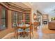 Bright breakfast nook with large windows, a round wooden table, and seating with pool view at 14244 Nottingham Way Cir, Orlando, FL 32828