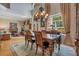 Elegant dining room with hardwood floors, chandelier lighting, with a view of the living room and front door at 14244 Nottingham Way Cir, Orlando, FL 32828